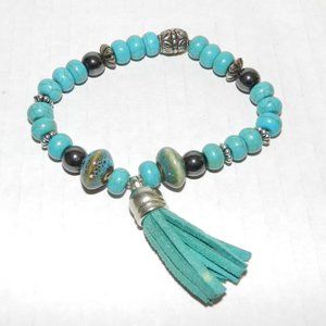 Faux turquoise and silver beads with leather tassel accent stretch bracelet
